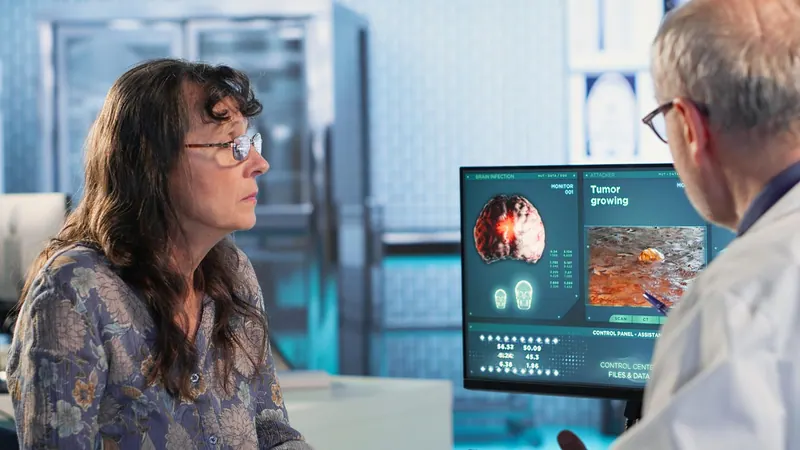 Patient and doctor discussing heart images on a monitor